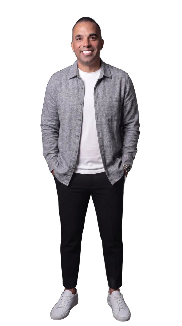 Tyler Perez in a heather-gray overshirt, white t-shirt, black trousers, and white sneakers